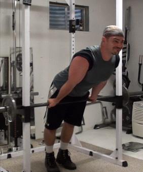 Rack-Leaning Barbell Curls to Wake Up Your Bicep Muscle Fibers