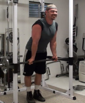 Rack-Leaning Barbell Curls to Wake Up Your Bicep Muscle Fibers