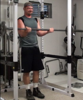 Rack-Leaning Barbell Curls to Wake Up Your Bicep Muscle Fibers